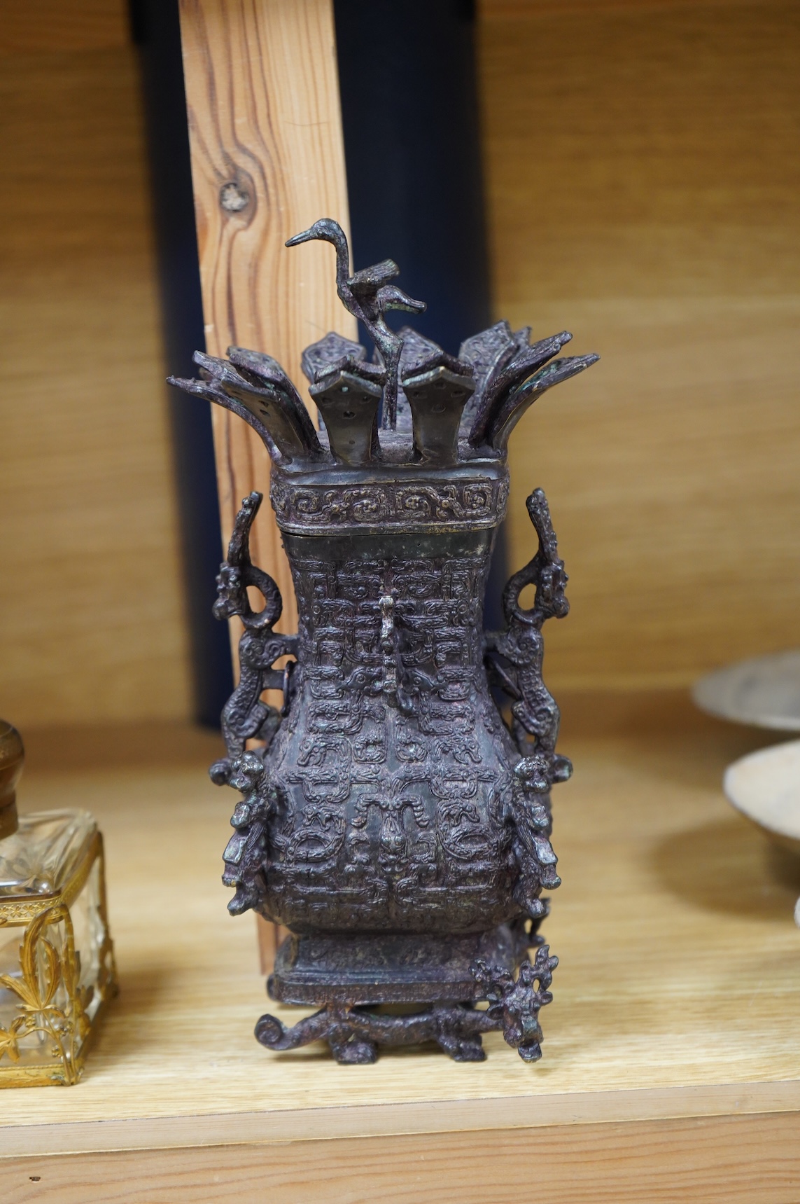 A Chinese Shang style bronze vessel and cover, 23cm